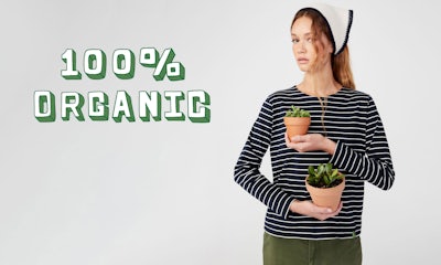 KULE-link to organics-Female model wearing The Modern Long Organic tee in navy/cream with The Wayne headscarf holding 2 potted succulents.