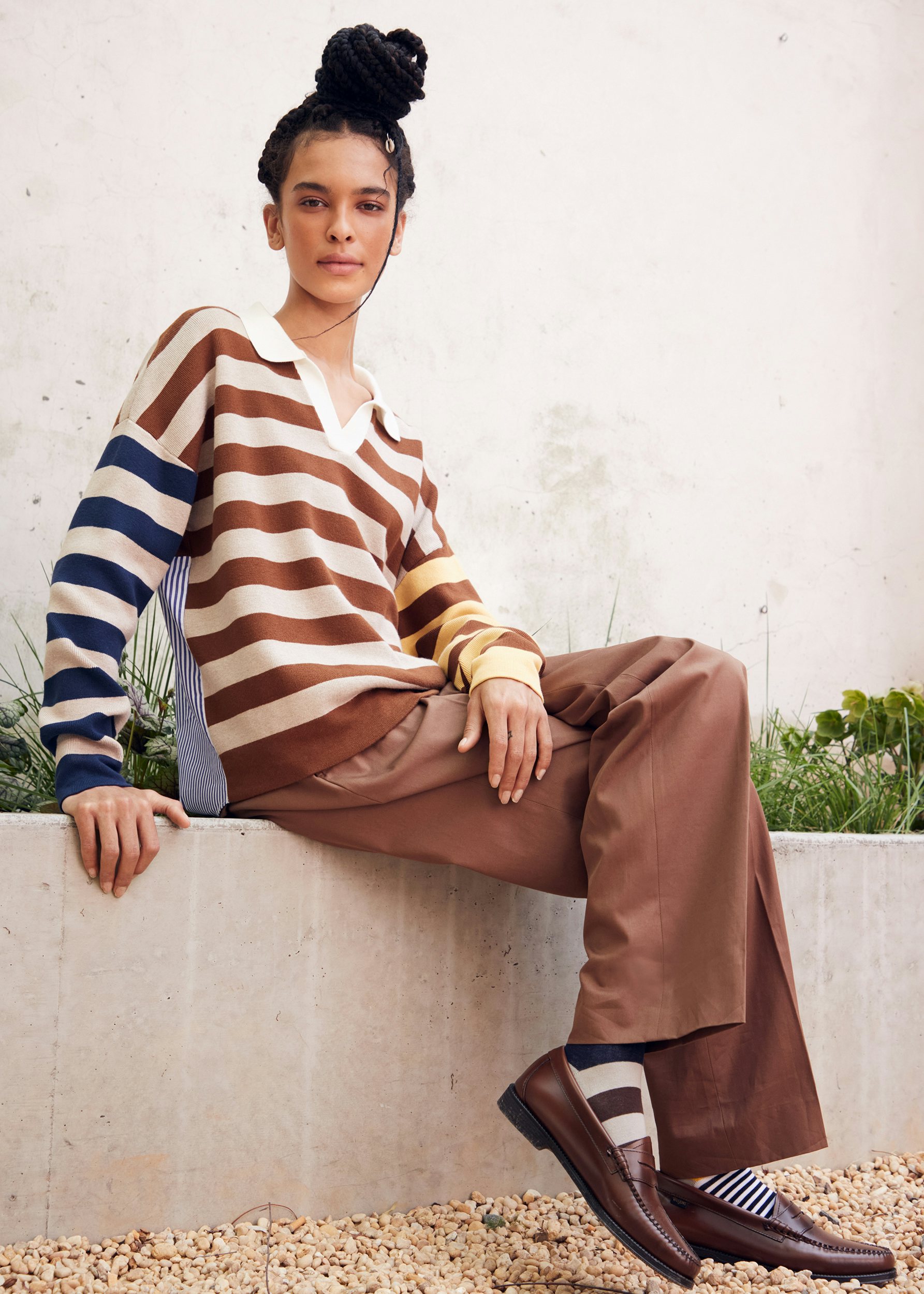 Model wearing the new Joey in latte, forest and gold stripes. It's a rugby look but in sweater material on the front and a woven shirt on the back. Super fun spin on the traditional rugby. She is wearing brown pants (not sold at KULE) and our matching latte rugby socks.