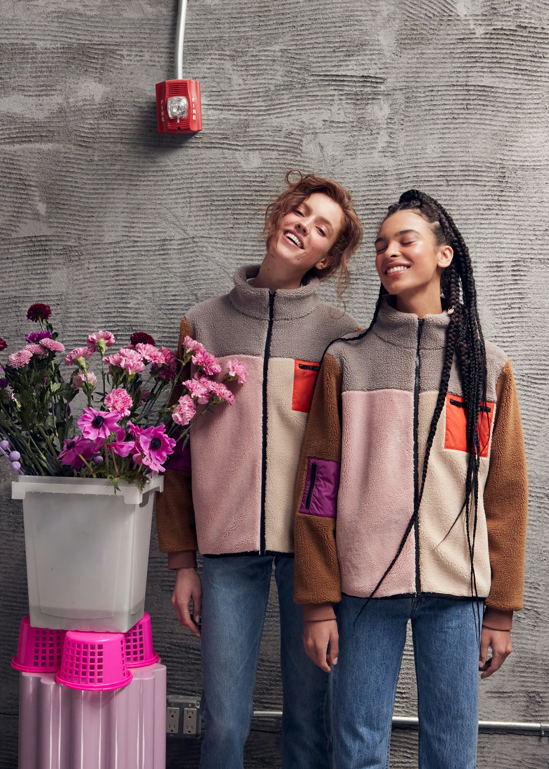 Two models wearing the new Beanie Jacket. It's the latest color for fall, with light pink, poppy, vicuna, and heather grey. 